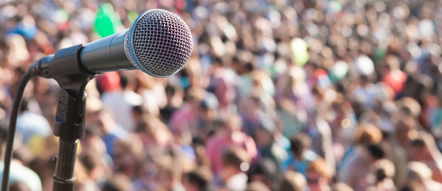 Microphone in front of crowd The Related Rentals Blog